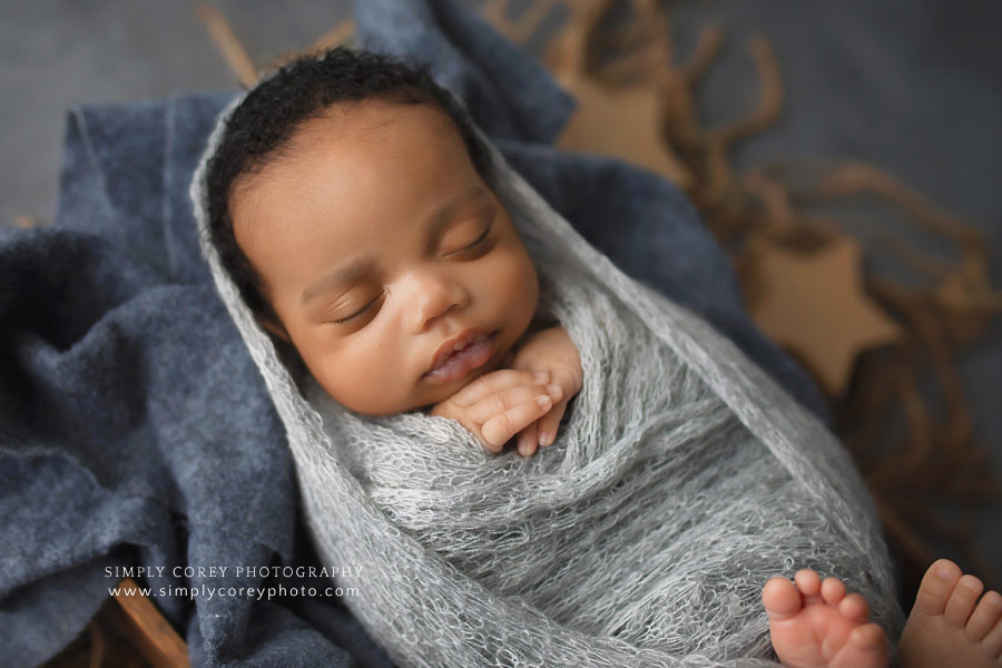 West Georgia newborn photographer, baby boy in gray wrap with stars