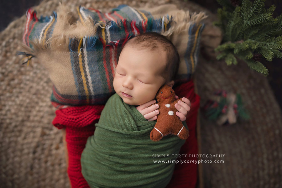 Atlanta newborn photographer, baby boy holding a gingerbread man