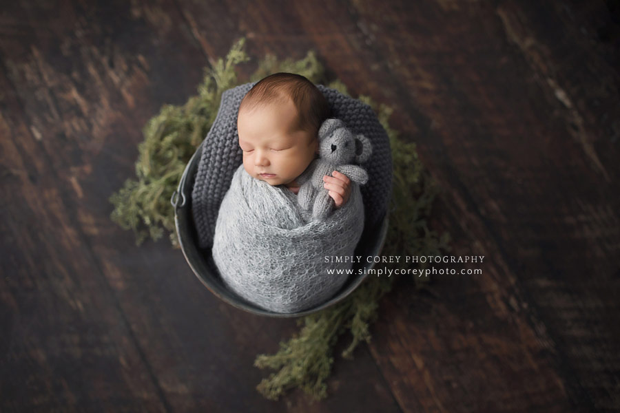 newborn photographer near Carrollton, Georgia; baby boy holding a teddy bear