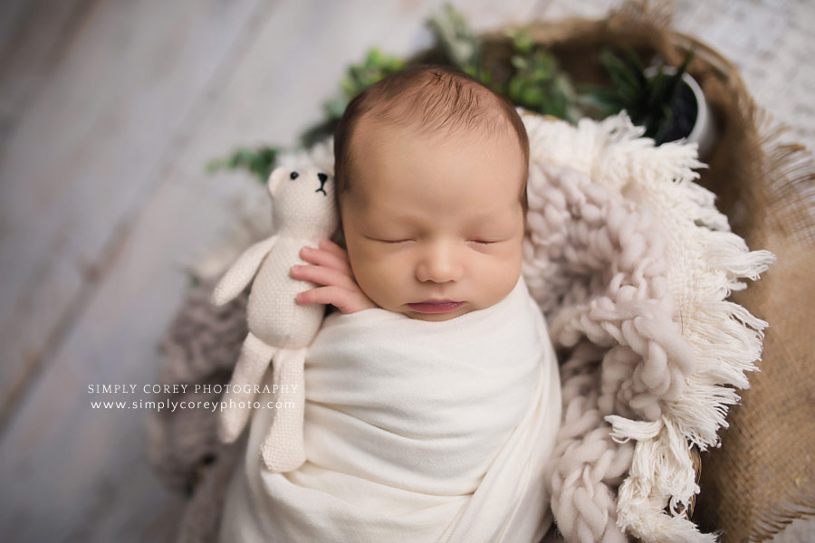 Atlanta newborn photographer, baby boy in ivory holding teddy bear