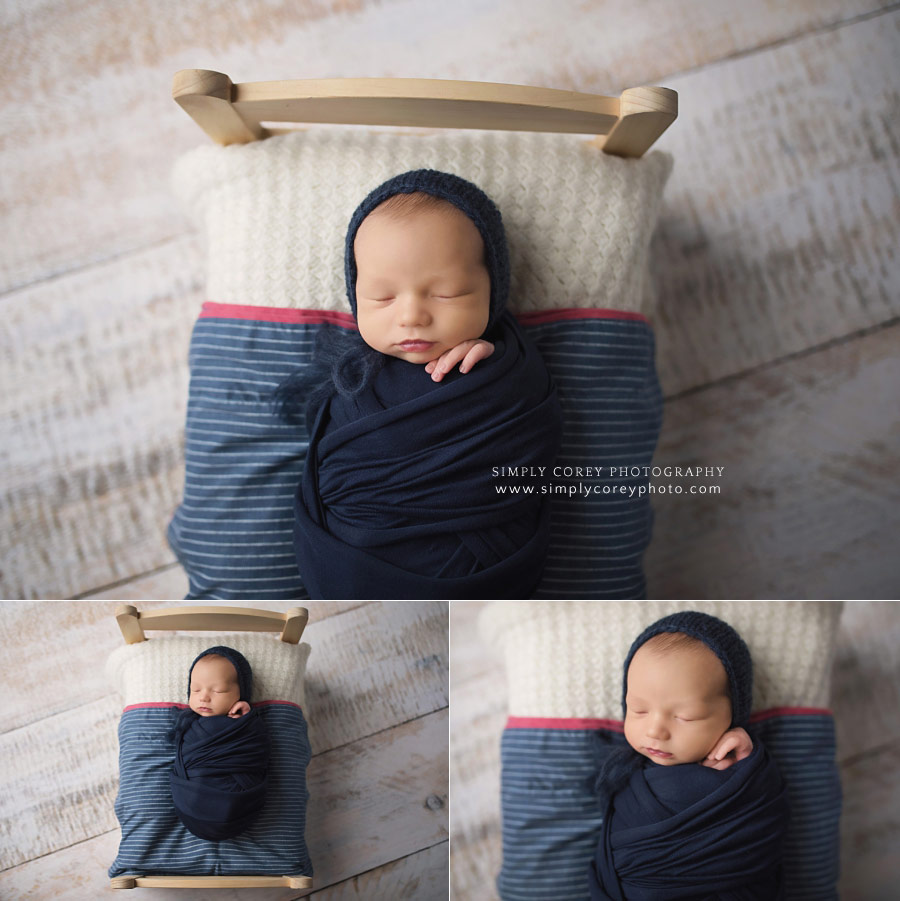 Villa Rica newborn photographer, baby boy in navy blue on a little bed