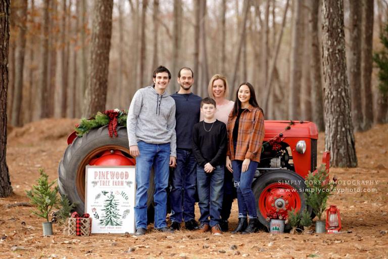                                                                                                                           Atlanta mini session photographer, family outside with Christmas tractor