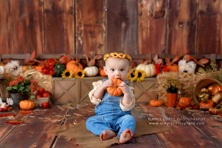 baby photographer near Carrollton, Georgia; girl holding pumpkin with fall theme