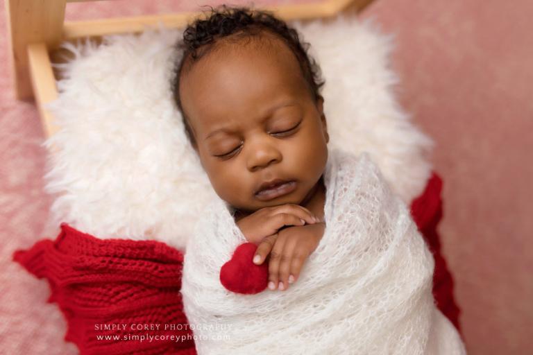 newborn photographer near Villa Rica, baby boy holding red felted heart