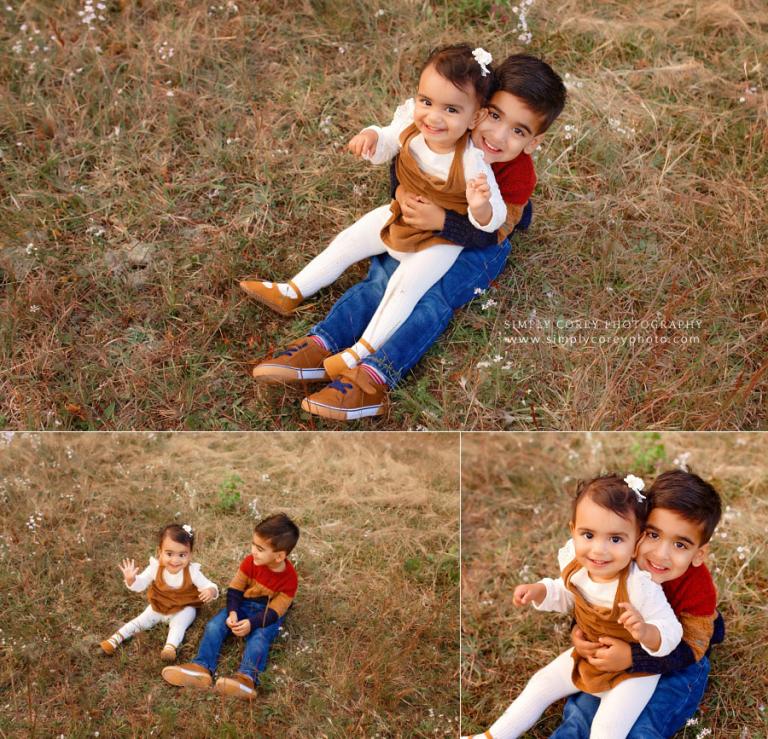 Douglasville family photographer, kids sitting in field for a fall session