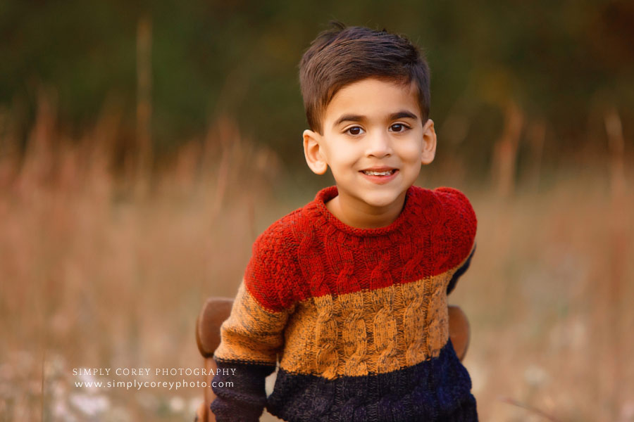 Villa Rica photographer, child outside in field for fall portrait session