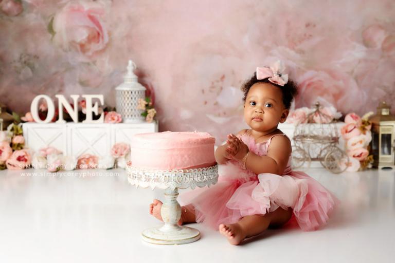 cake smash photographer near Dallas, GA; baby girl with pink floral set