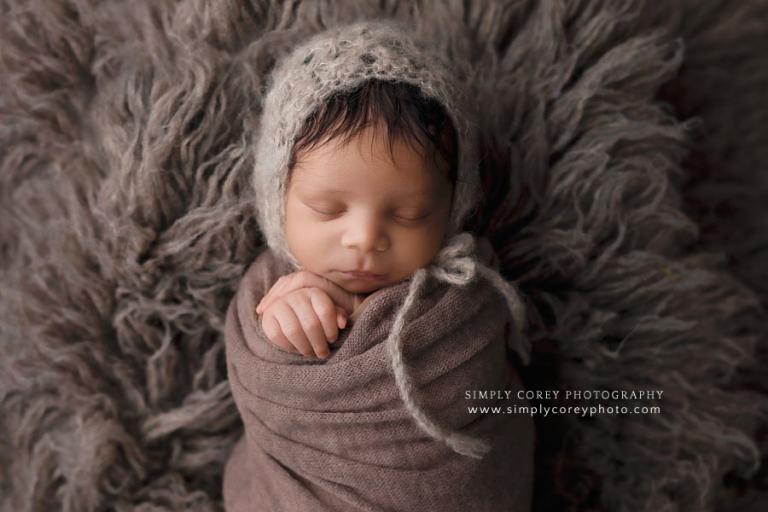 Atlanta newborn photographer, baby boy on brown flokati fur