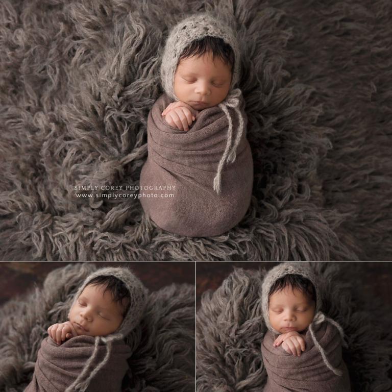 newborn photographer near Douglasville, swaddled baby on brown flokati fur