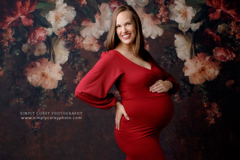 maternity photographer near Atlanta, studio portrait with floral backdrop