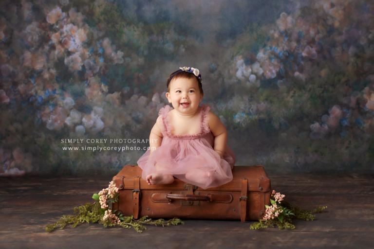Atlanta baby photographer, sitter session with vintage suitcase and floral backdrop