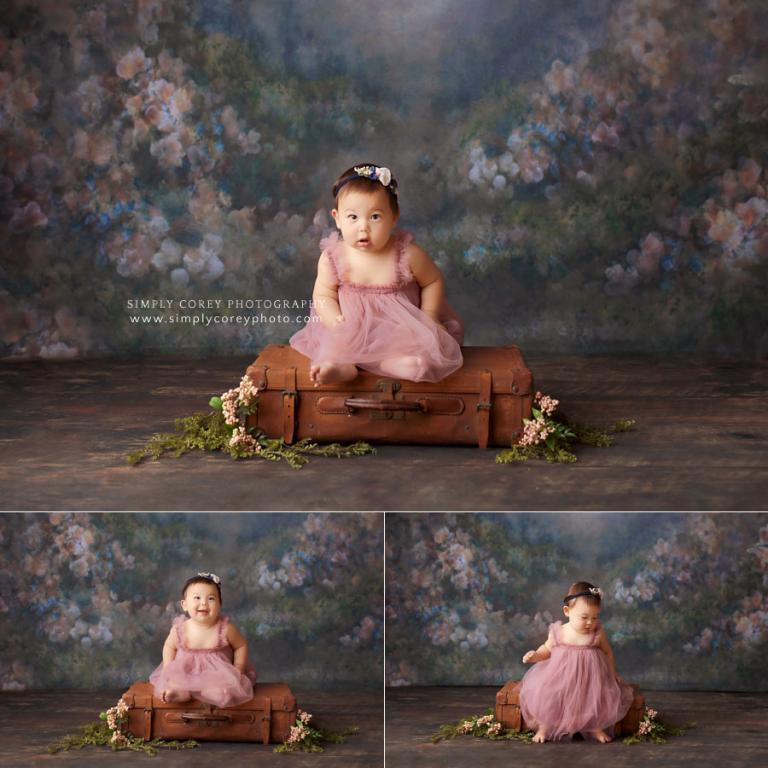 Douglasville baby photographer, vintage suitcase and floral backdrop in studio