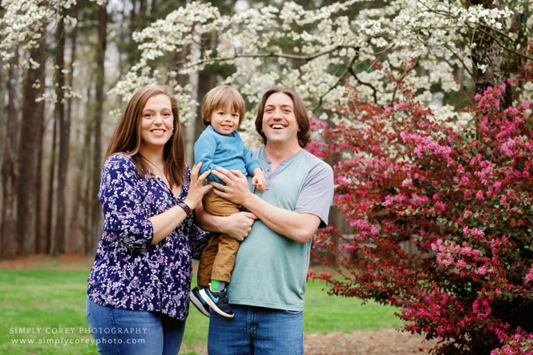 family photographer near Carrollton, GA; spring portrait by dogwood tree and spring blossoms