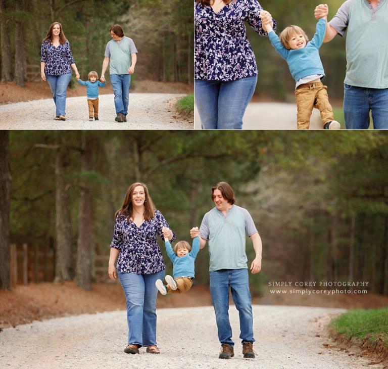 West Georgia family photographer, parents swinging toddler outside on country road