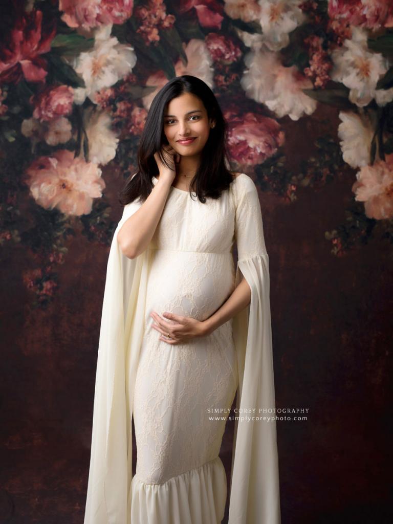 Atlanta maternity photographer, mom in flowy sleeves with floral backdrop