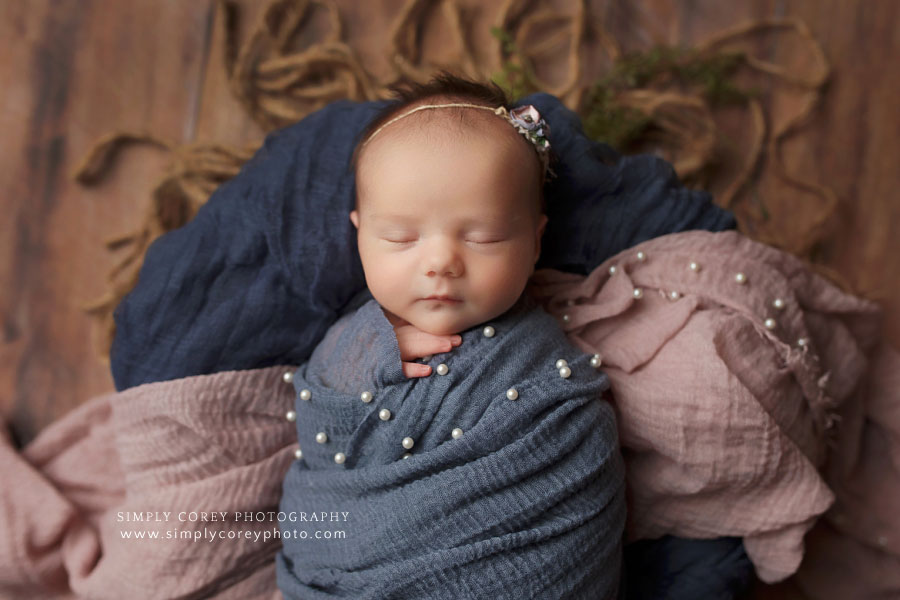 Atlanta newborn photographer, baby girl with navy and mauve wraps with pearls in basket