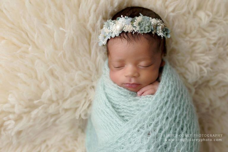 Carrollton newborn photographer, baby girl in mint green wrap with flower crown