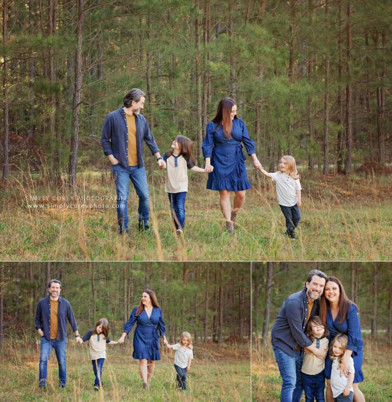 family photographer in West Georgia, parents walking with kids outside in field