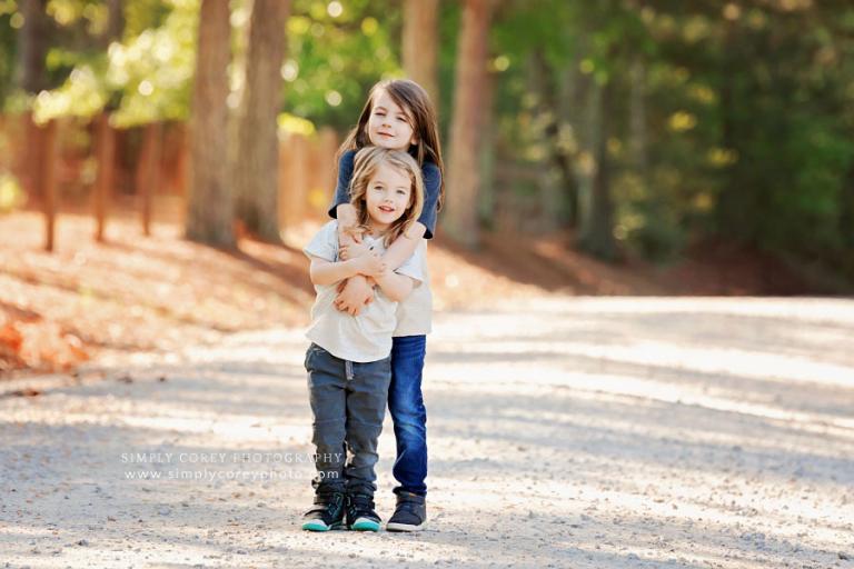 Newnan family photographer, portrait of kids outside on country road