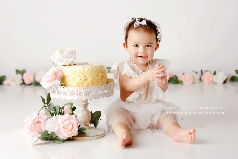 Atlanta cake smash photographer, baby girl with white studio set and pink flowers
