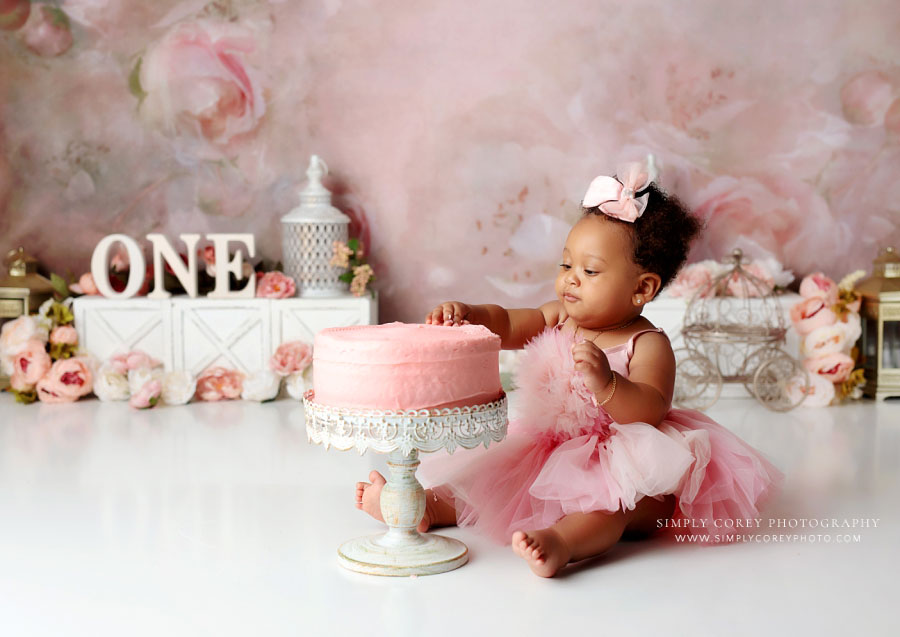 Atlanta cake smash photographer, baby eating pink cake in studio