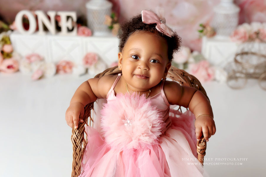 baby photographer near Douglasville, one year old smiling in pink tulle dress
