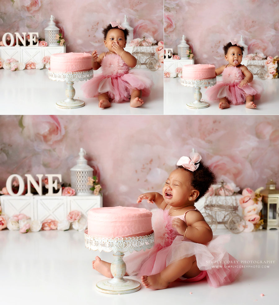 Villa Rica baby photographer, girl crying at end of pink floral cake smash