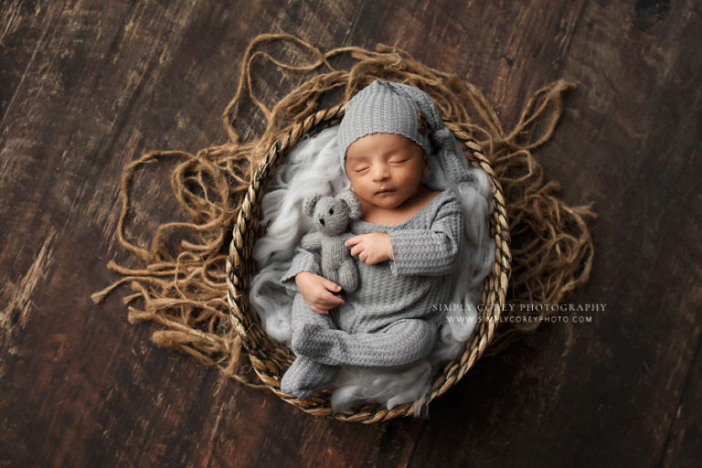 Atlanta newborn photographer, baby boy in gray sleeper in brown basket