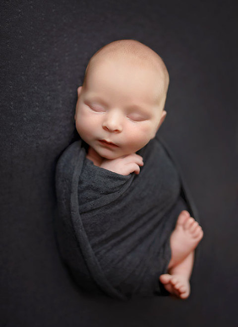 Carrollton newborn photographer in Georgia, baby boy swaddled in gray