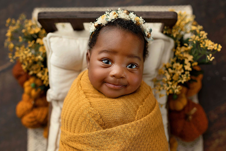 newborn photographer near Villa Rica, baby girl in fall colors with pumpkins
