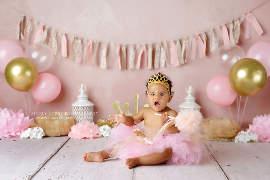 baby photographer in West Georgia, girl making funny face during princess studio milestone session