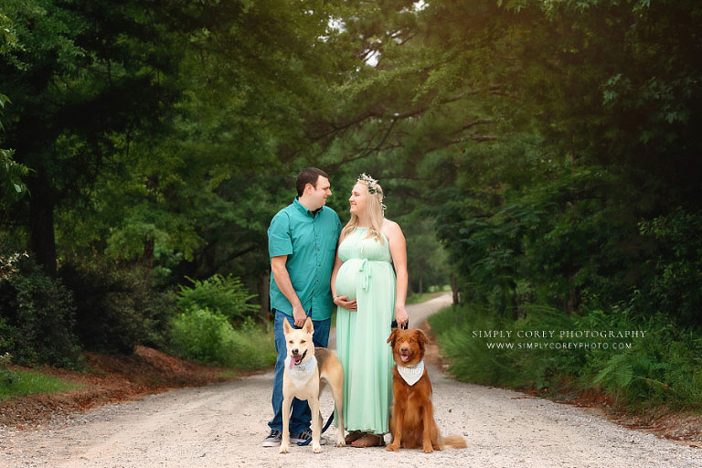 Atlanta maternity photographer, couple outside on country road with two dogs