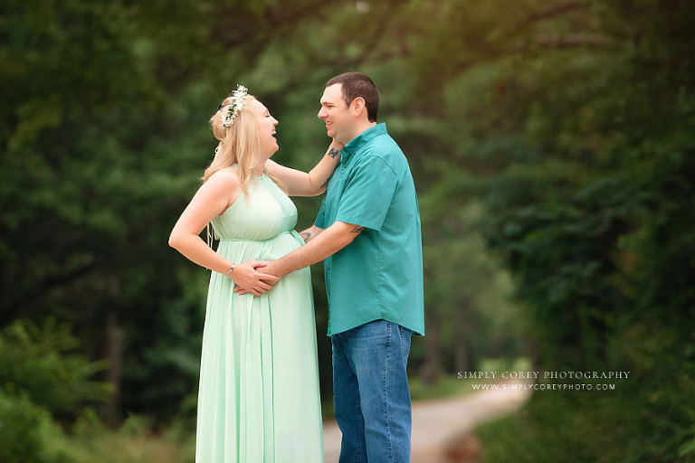 maternity photographer near Atlanta, couple in green outside on country road