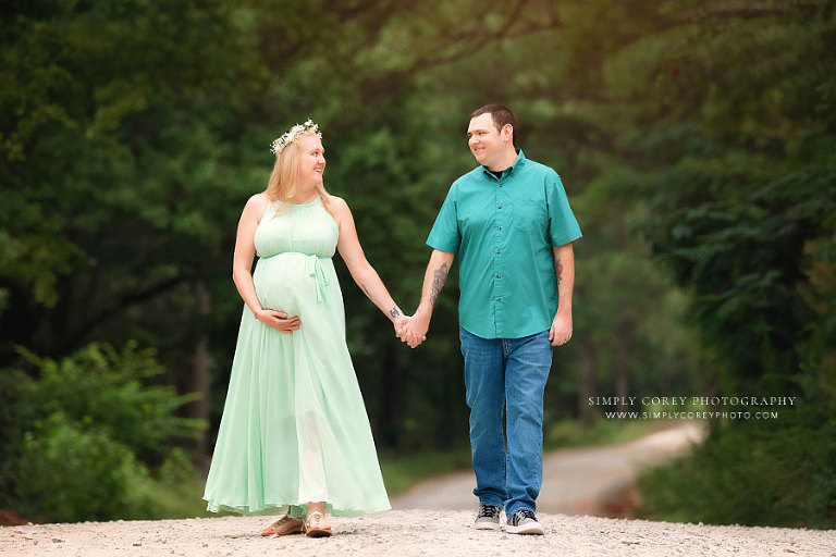 maternity photographer near Hiram, couple walking on country road in summer