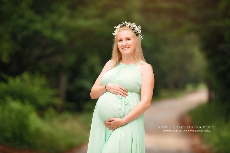 maternity photographer near Villa Rica, mom in green dress and flower crown outside in summer