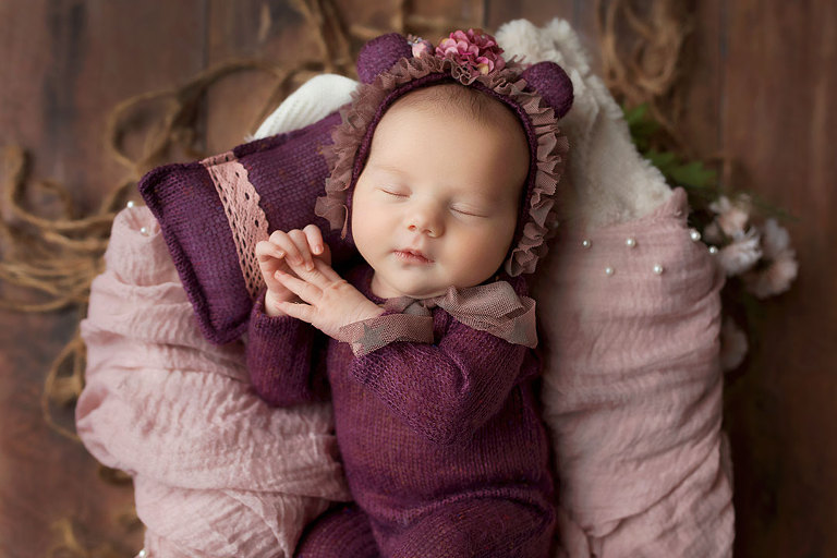 newborn photographer near Austell in West Georgia, baby girl in purple bear outfit