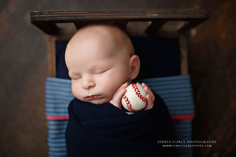 Atlanta newborn photographer, baby boy in navy holding baseball