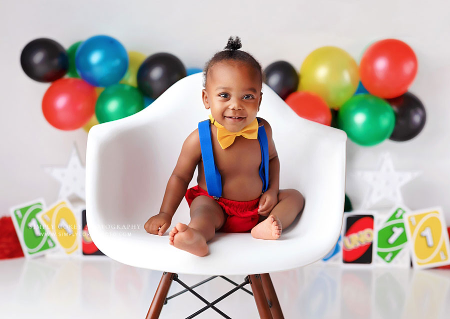 baby photographer near Villa Rica, boy with suspenders and chair for one year milestone session