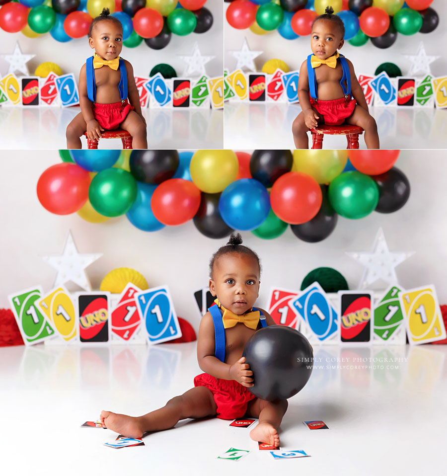 baby photographer in west Georgia, boy with suspenders and balloons for uno studio theme