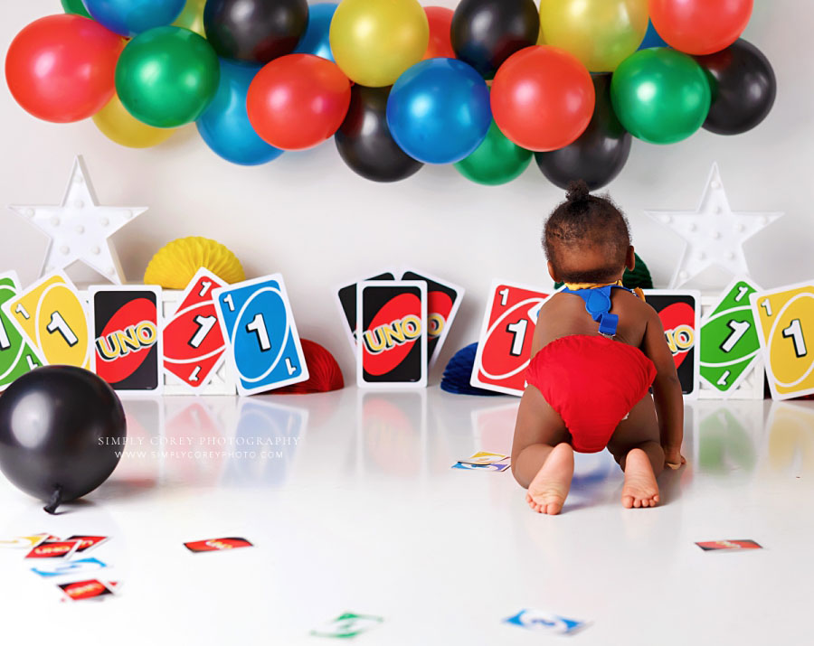 West Georgia baby photographer, boy crawling away on uno studio milestone set