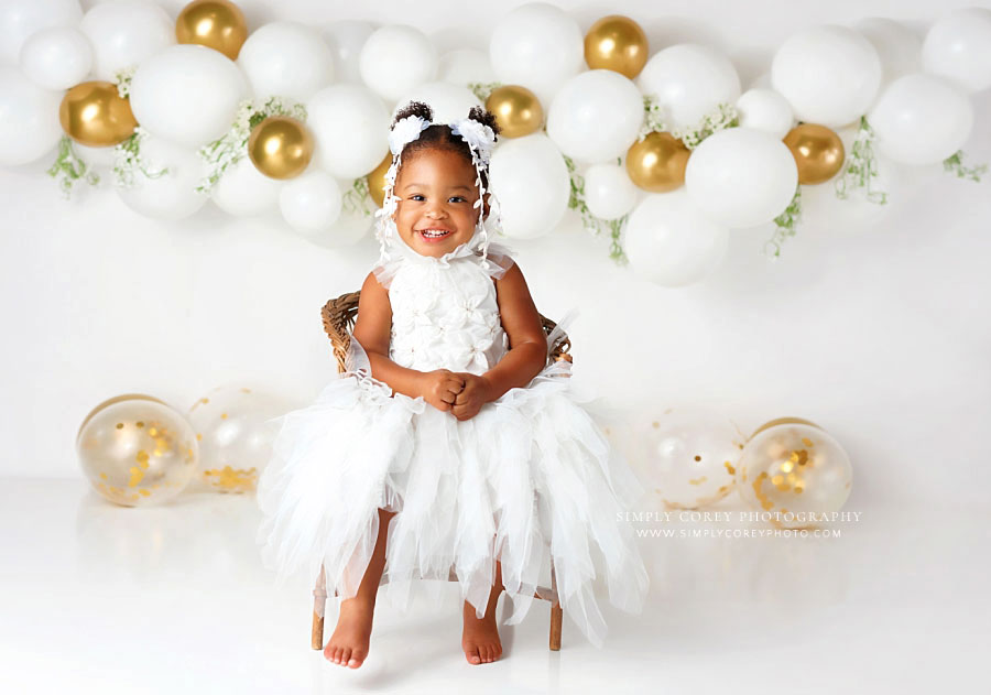 baby photographer near Atlanta, one year old girl white and gold studio milestone session with balloons