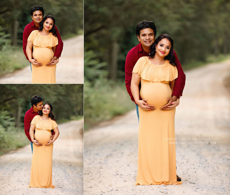 Mableton maternity photographer, expecting couple in burgundy and mustard outside on road