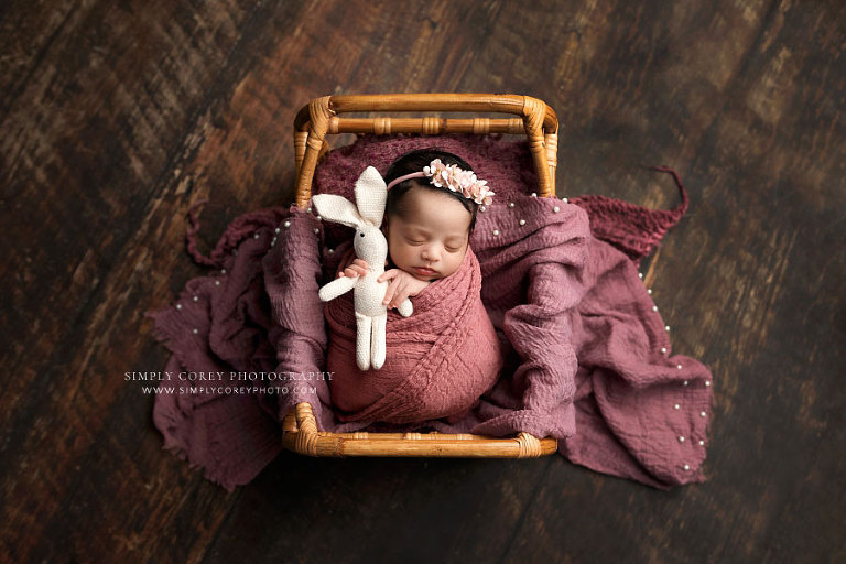 Atlanta newborn photographer, baby girl wrapped in pink holding bunny