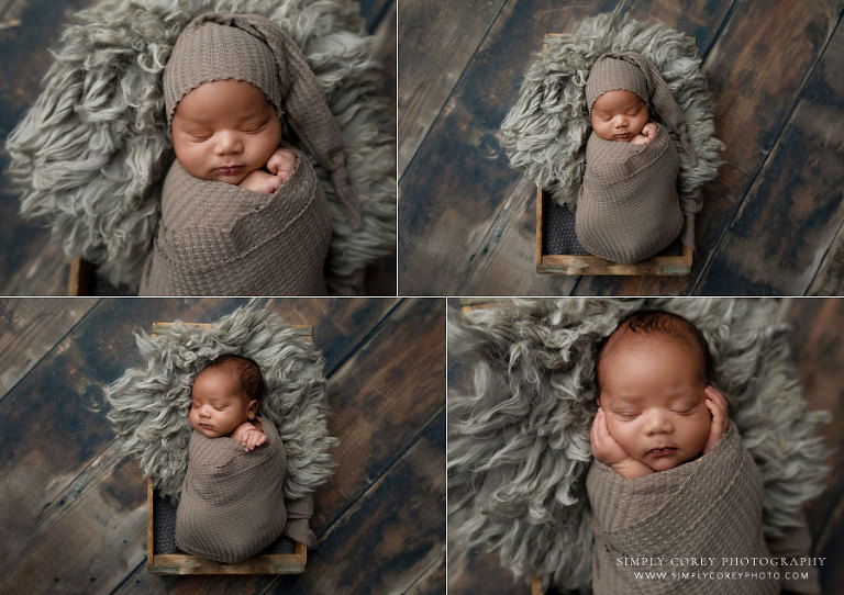 newborn photographer near Dallas, Georgia; baby boy in wrap and sleepy cap on flokati