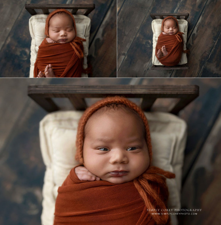 newborn photographer near Douglasville, baby boy on little bed in burnt orange set