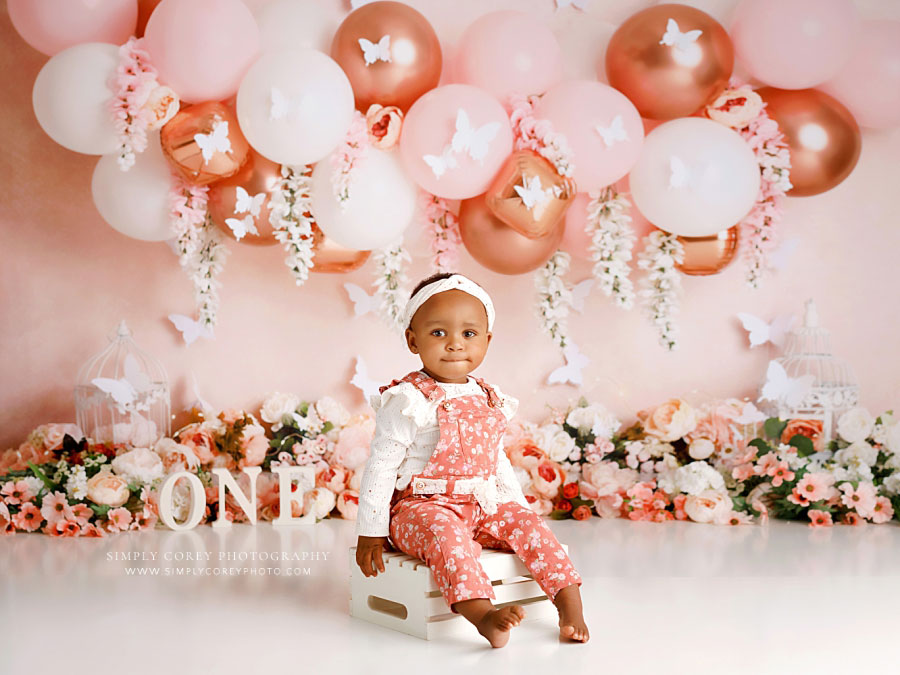 baby photographer near Villa Rica, pink floral butterfly milestone session with balloon garland