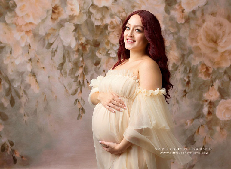 maternity photographer near Newnan, studio session with floral backdrop and tulle dress