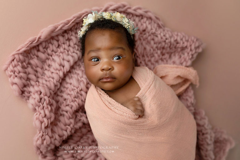newborn photographer near Atlanta, awake baby girl with rose pink studio set