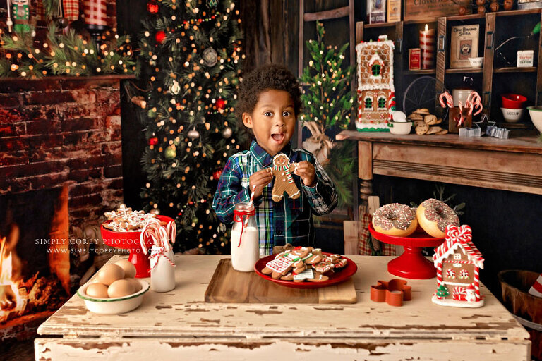 mini session photographer near Atlanta, child with cookie in Christmas kitchen studio set