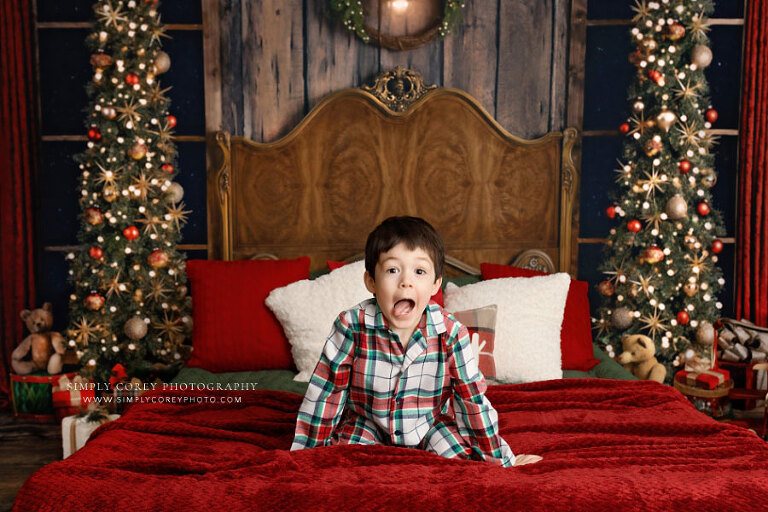 mini session photographer near Hiram, child making funny face in Christmas pajamas